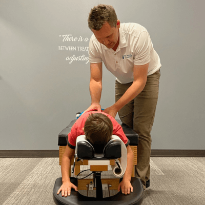 DOctor adjusting a younger boy