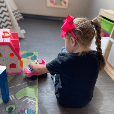 Little girl playing with a car