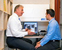 Dr. Priestley reviewing a patients exam findings. Dr. Priestley reviewing a patients exam findings.