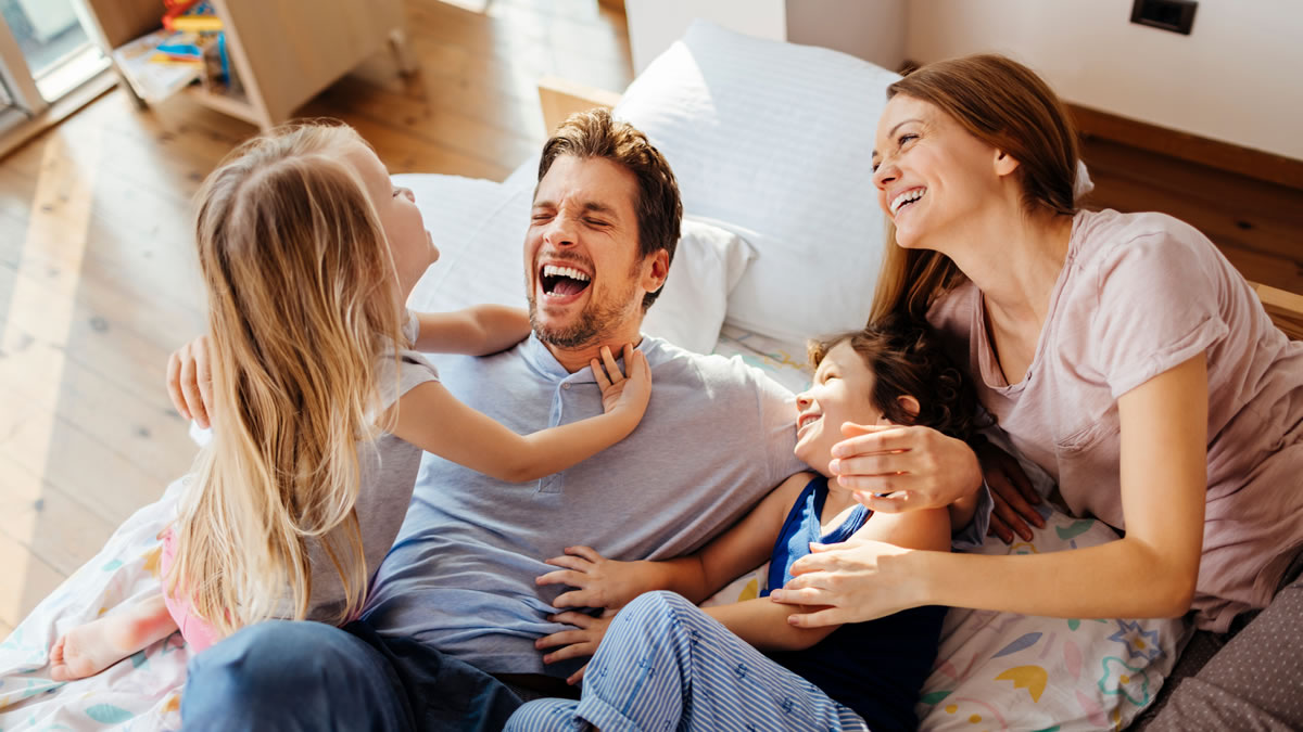 family having fun on bed