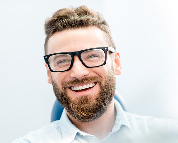 Man with glasses smiling
