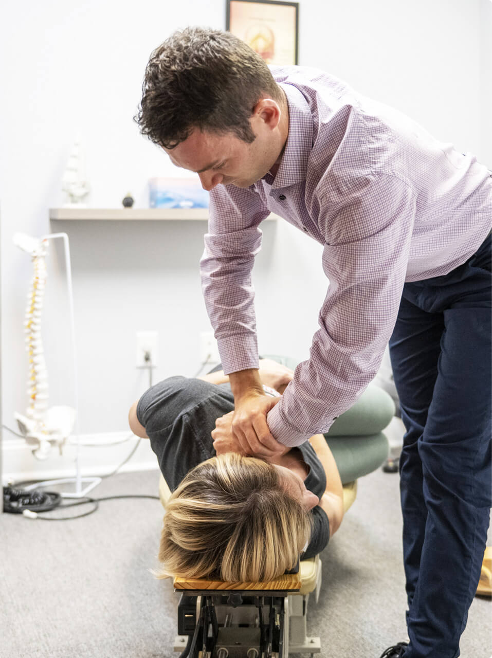 Chiropractor cracking patients back