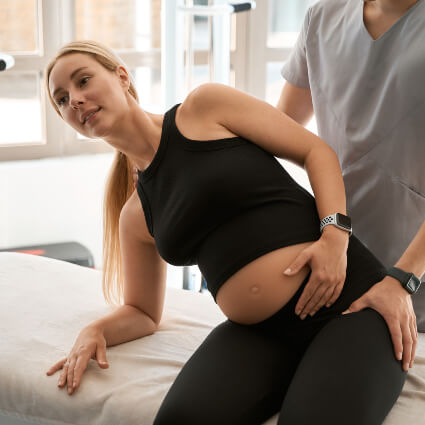 Pregnancy woman receiving a chiropractic adjustment