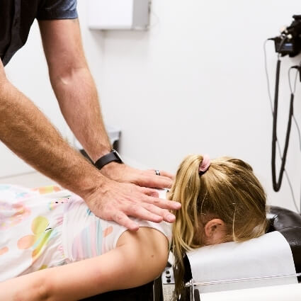 Dr Mark adjusting kids back