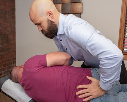 chiropractor adjusting lower back