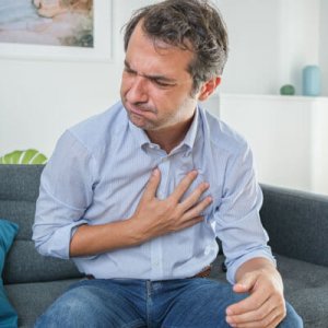 man holding chest in pain
