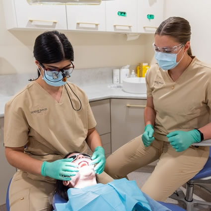 dentist checking female patients teeth
