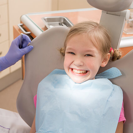 Young girl smiling in dental chair