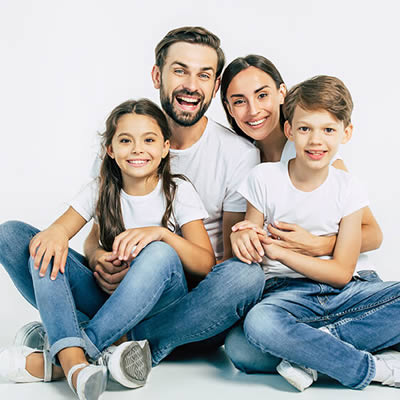 family sitting wearing white shirt