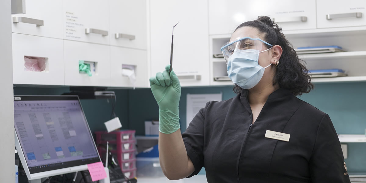 Hygienist holding up dental tool