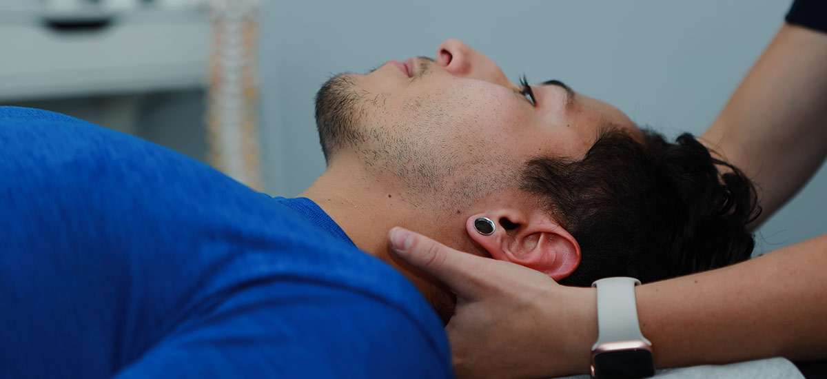 chiropractor adjusting patients neck