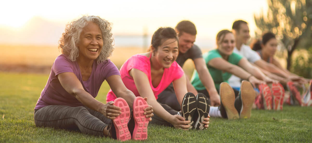 group stretching in park