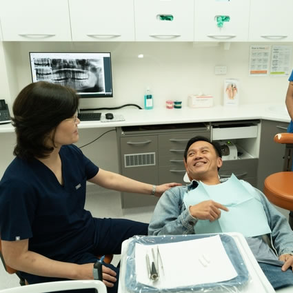 male patient smiling in chair during dental visit