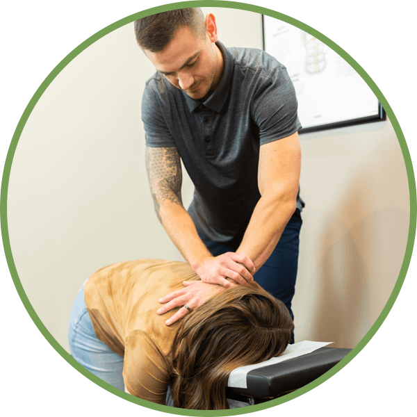 Chiropractor adjusting patients back