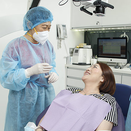 patient in chair smiling at dentist