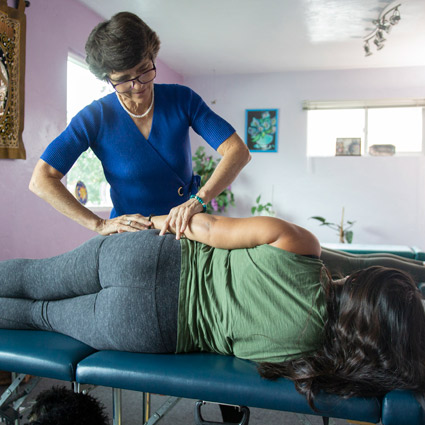 Patient lying on their side being adjusted.