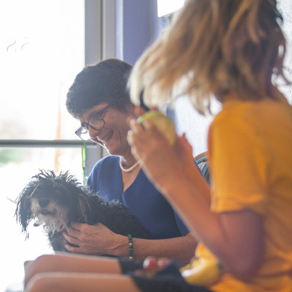 Dr. Joanne Haupert with her dog, Blueberry, in her lap in the patient waiting area.