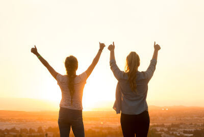 happy-females-woman-with-arms-out-in-mountains-inspirational