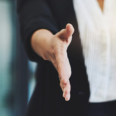 person holding out hand for handshake