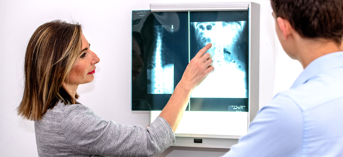 Dr. Leisha looking at x-rays with a client