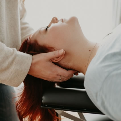 Dr. Jo Anne cradling a patients head in her hands