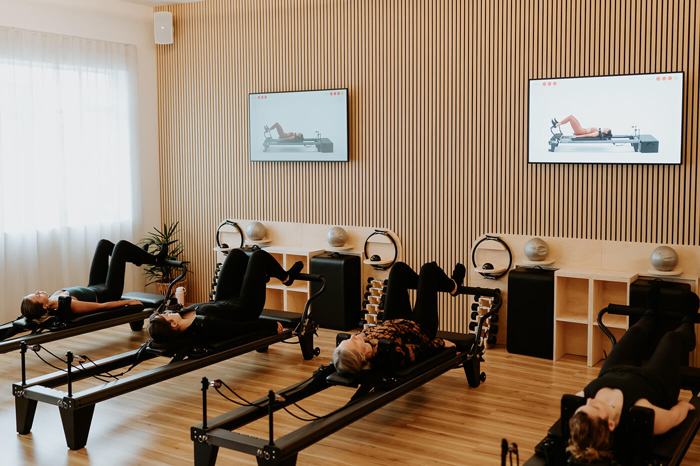 on screen instructed reformer pilates class