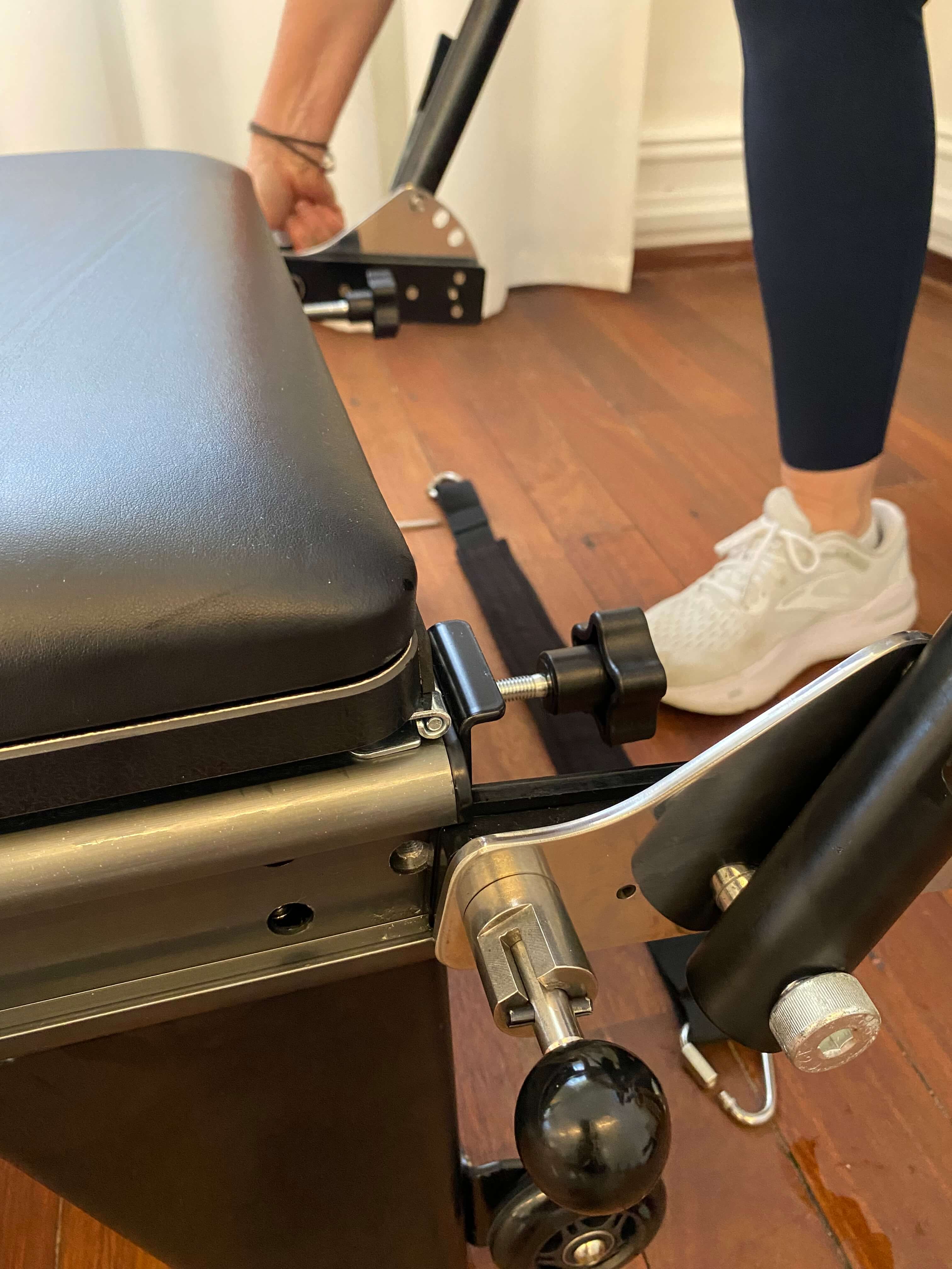 Sliding the foot bar into the reformer rails