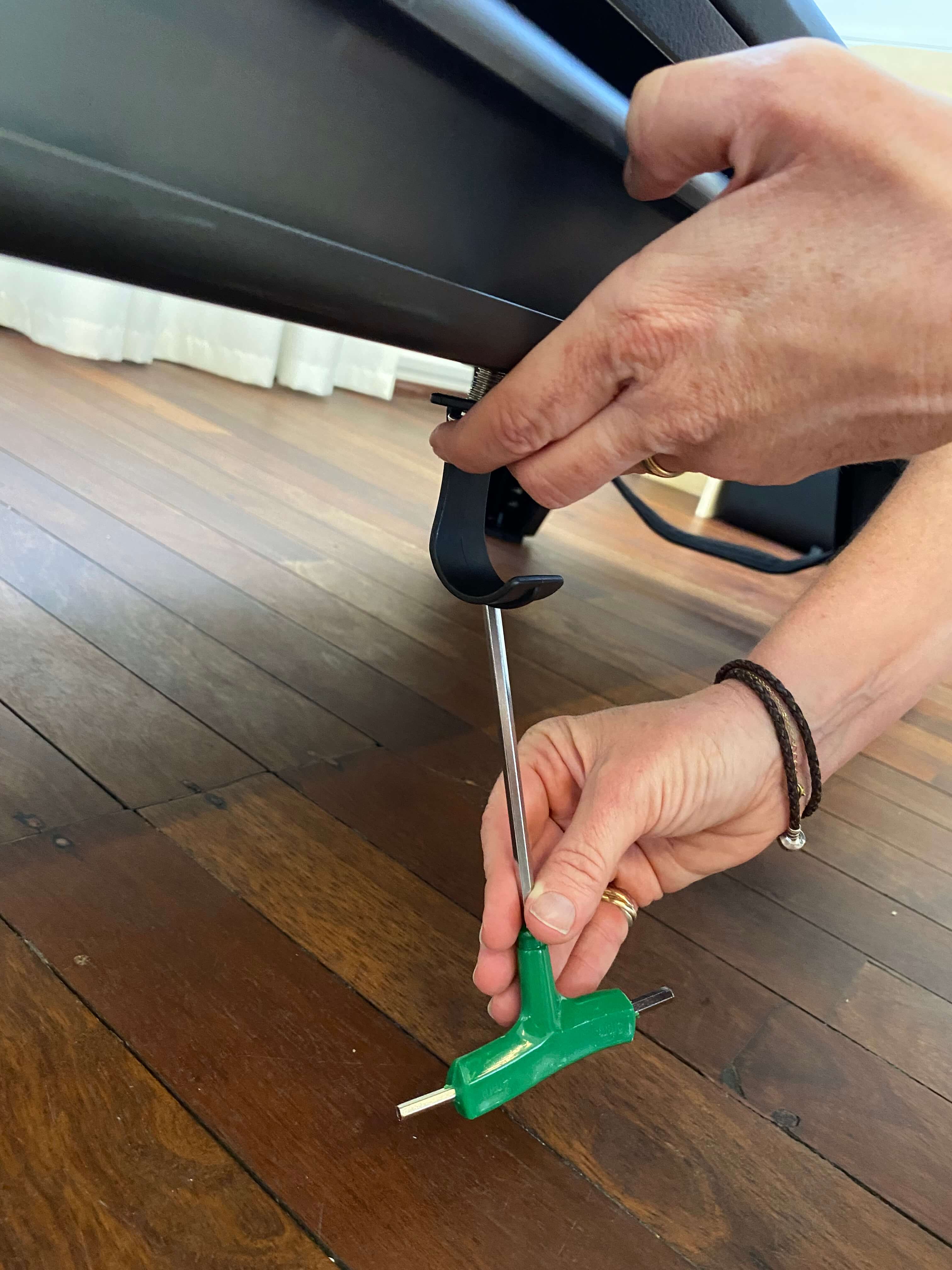 Hooks attached to the underside of the reformer using pre-drilled holes