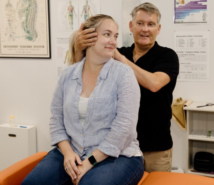 Dr. Bernard adjusting a patient's neck
