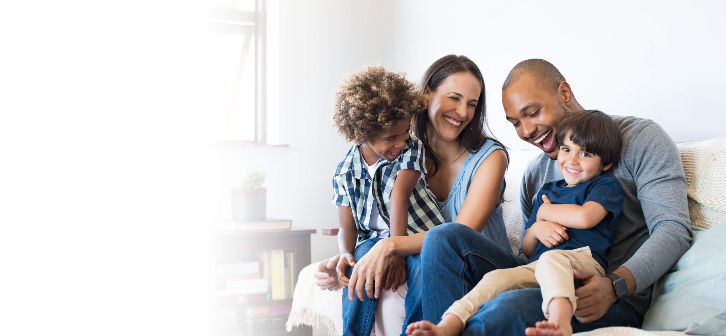 family smiling sitting on couch