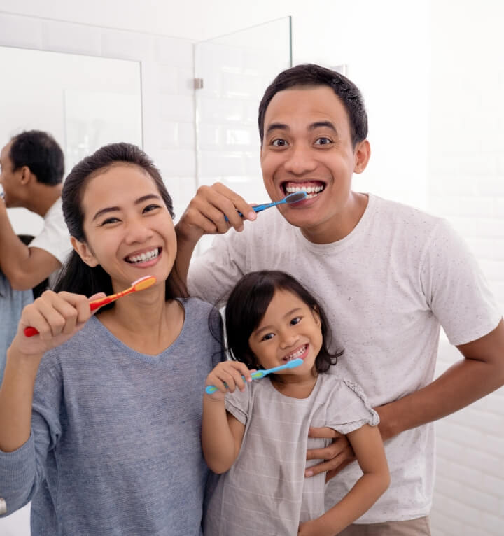 family brushing teeth together