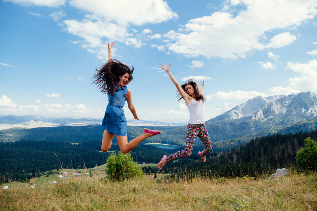 happy women travel and jump together