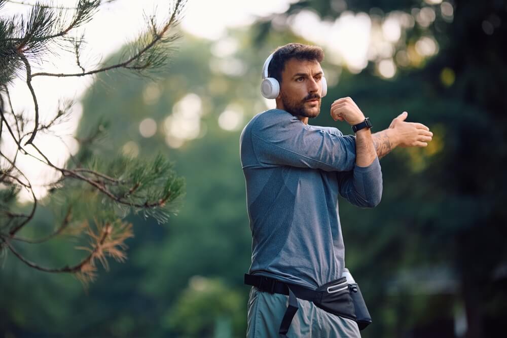 Athletic,Man,Stretching,His,Arms,During,Sports,Training,In,Nature.