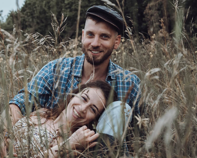 Couple smiling in field