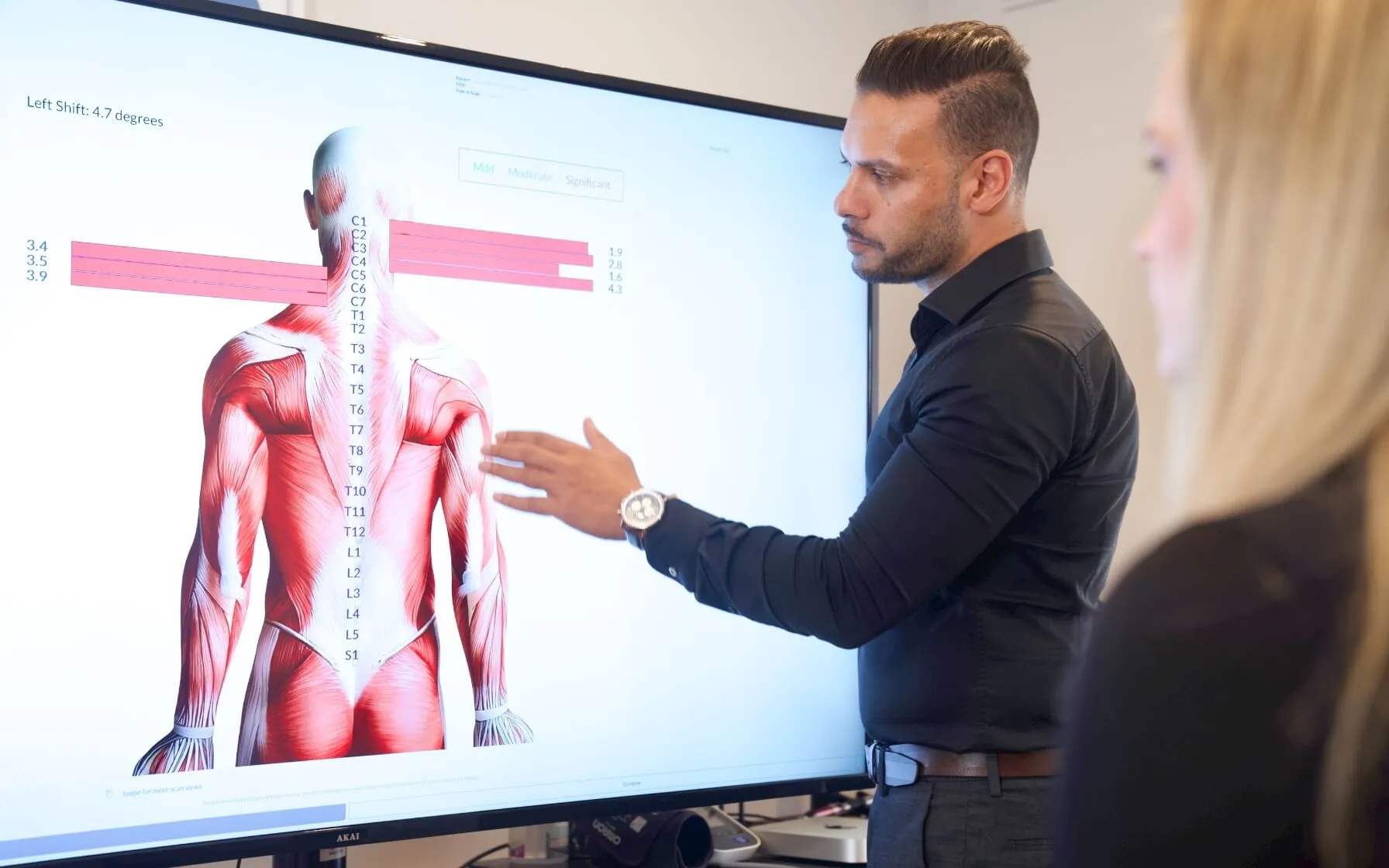 Chiropractor showing picture to patient