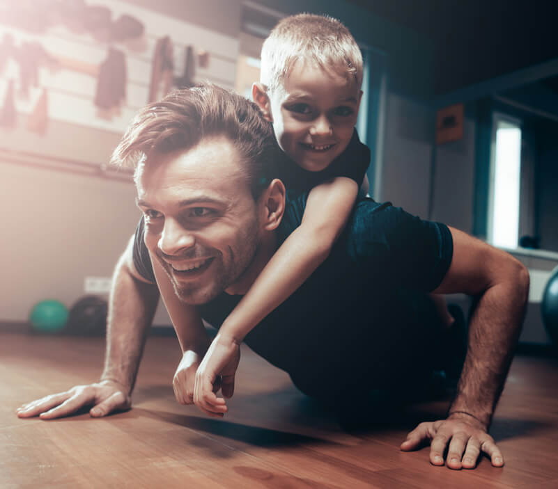 father and son doing push-ups