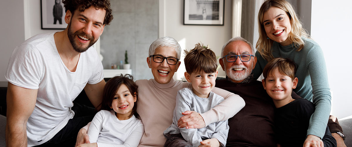 smiling family sitting on couch