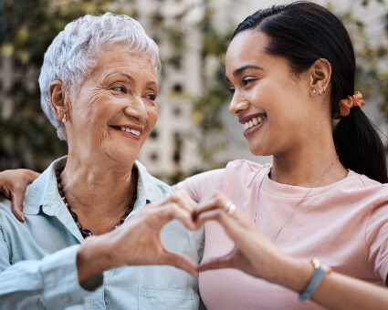 Adult women making heart shape with hands