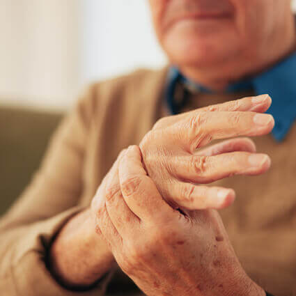 closeup man squeezing painful hand