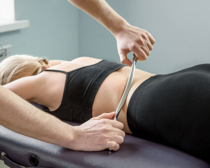 Graston technique used on female patient