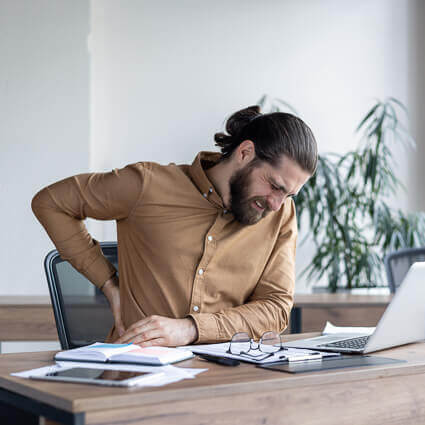 man at office with back pain