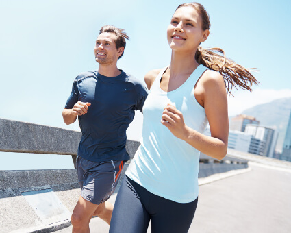 Man and woman running outdoors