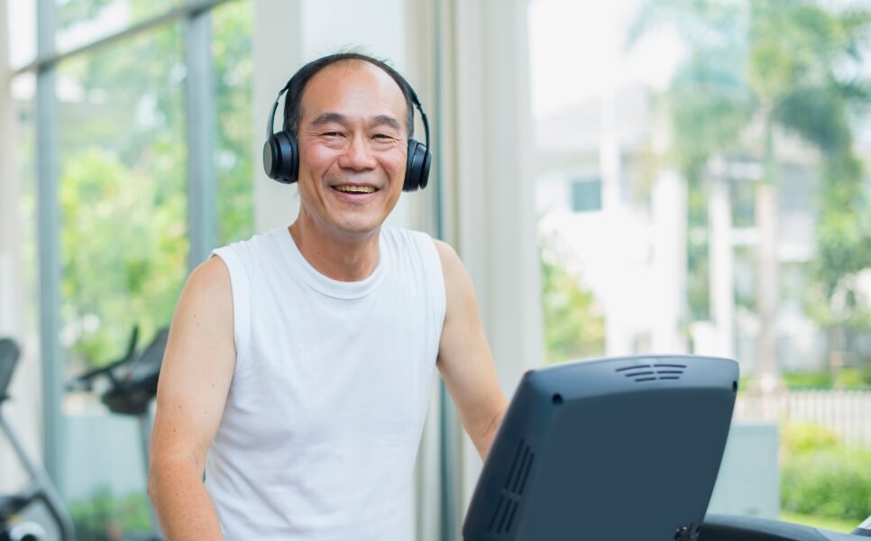 man smiling on exercise equipment