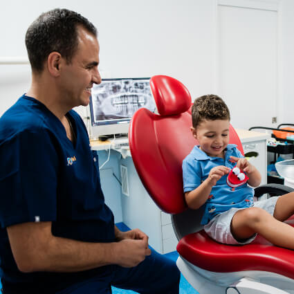 Child looking at teeth model