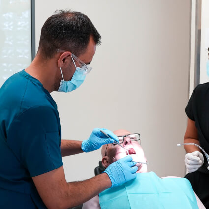 Hervey Bay dentist Dr Felipe examining patients mouth