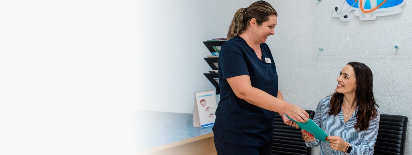 Hervey Bay dentsit Dr Felipe talking with patient