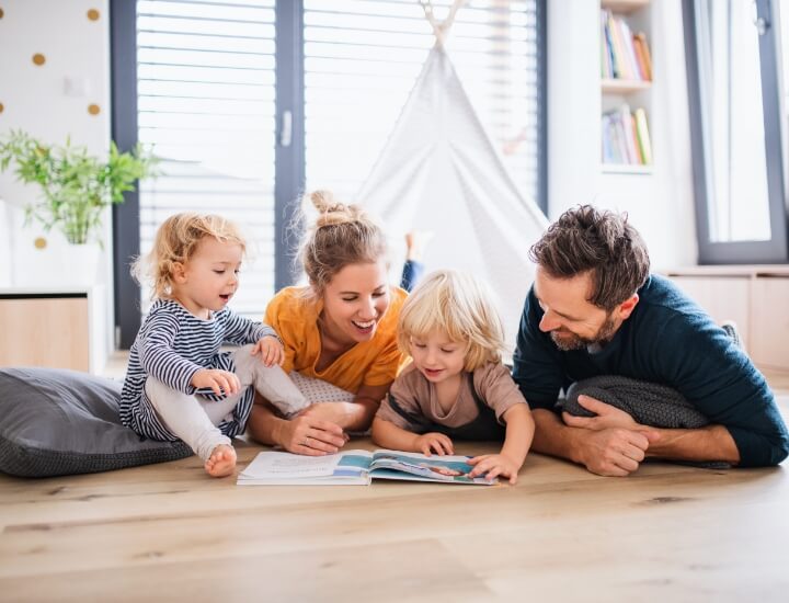 family happily reading a book