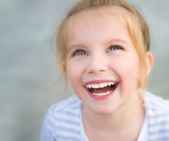 A little girl smiling