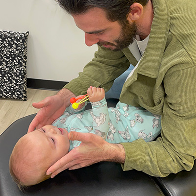 doctor adjusting baby on table