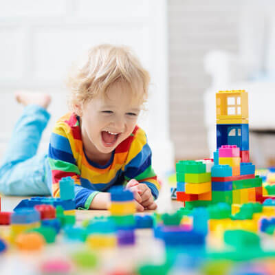 toddler with building blocks